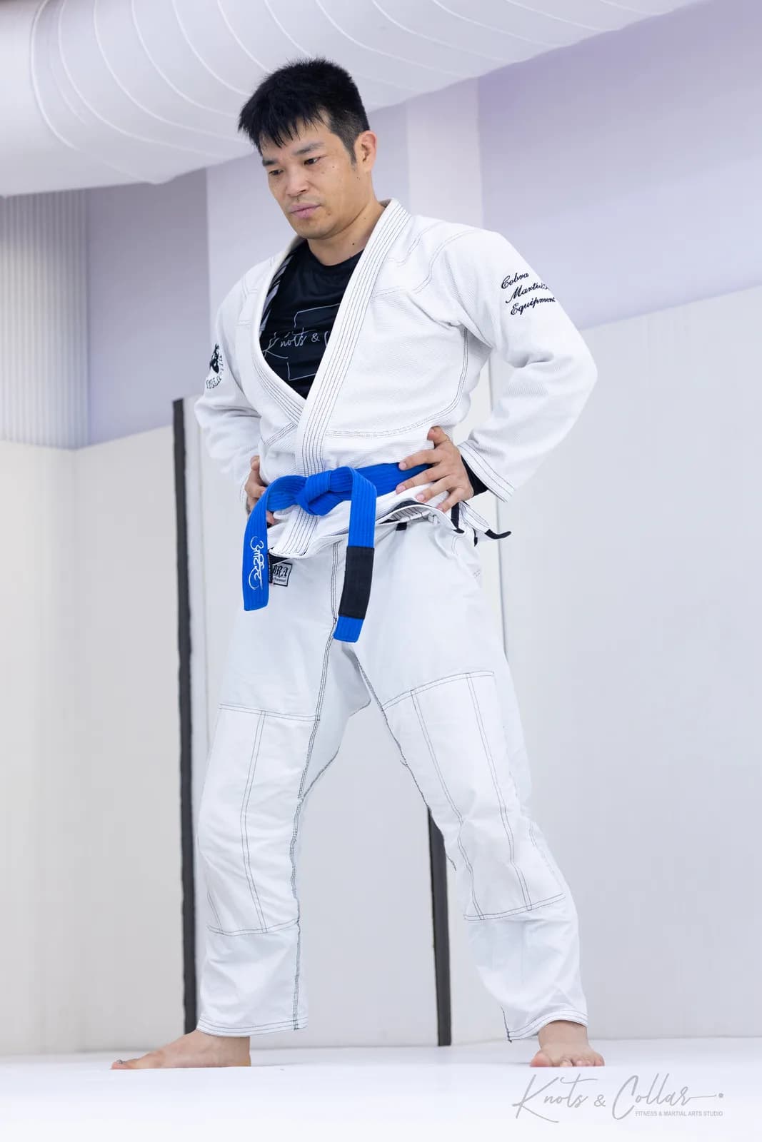 A blue belt in a white gi during a private Brazilian Jiu-Jitsu personal training session at Knots & Collar, New Delhi