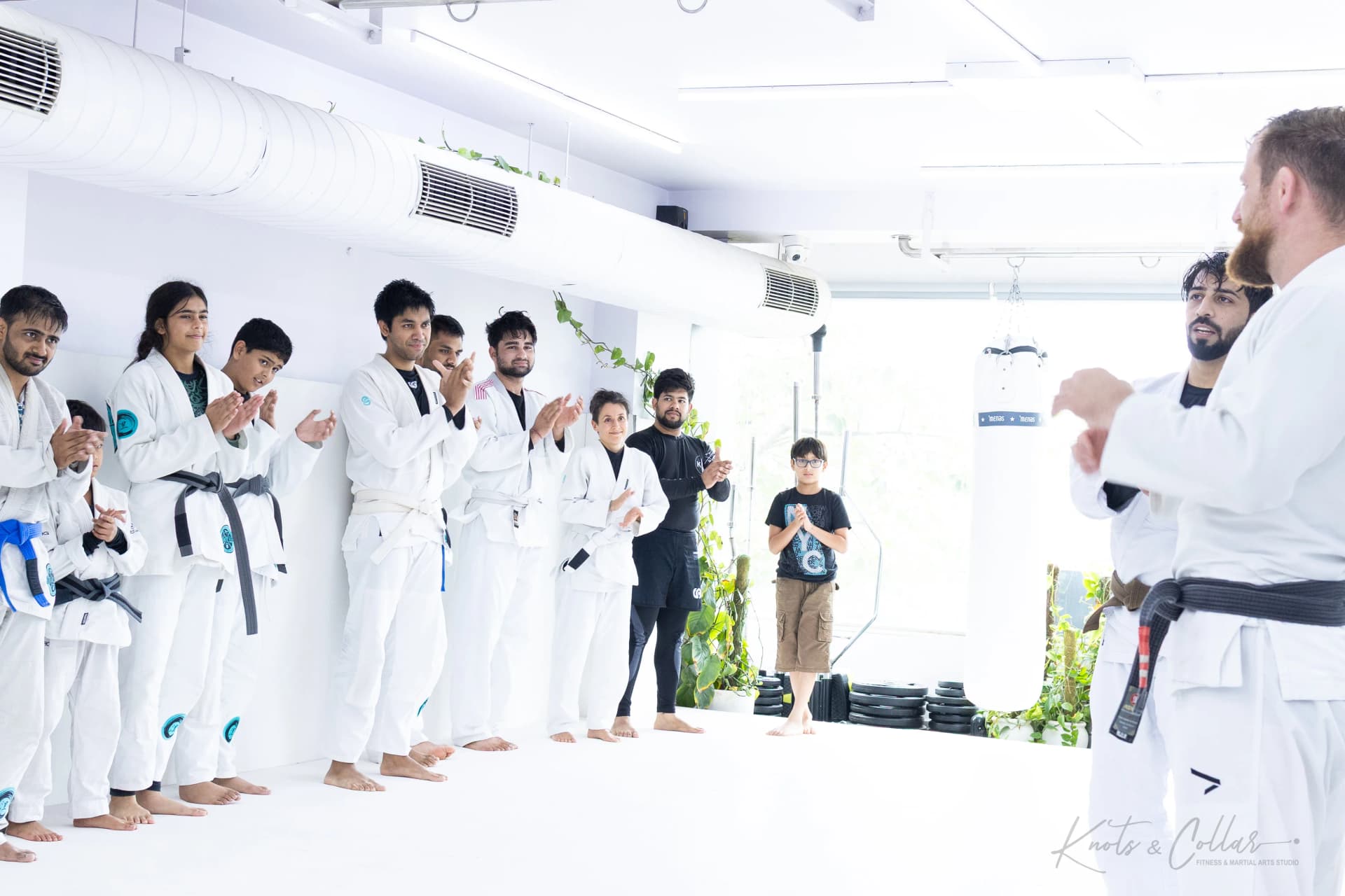 Students lined up applauding at the close of a Jiu-Jitsu seminar at the Knots & Collar studio, New Delhi