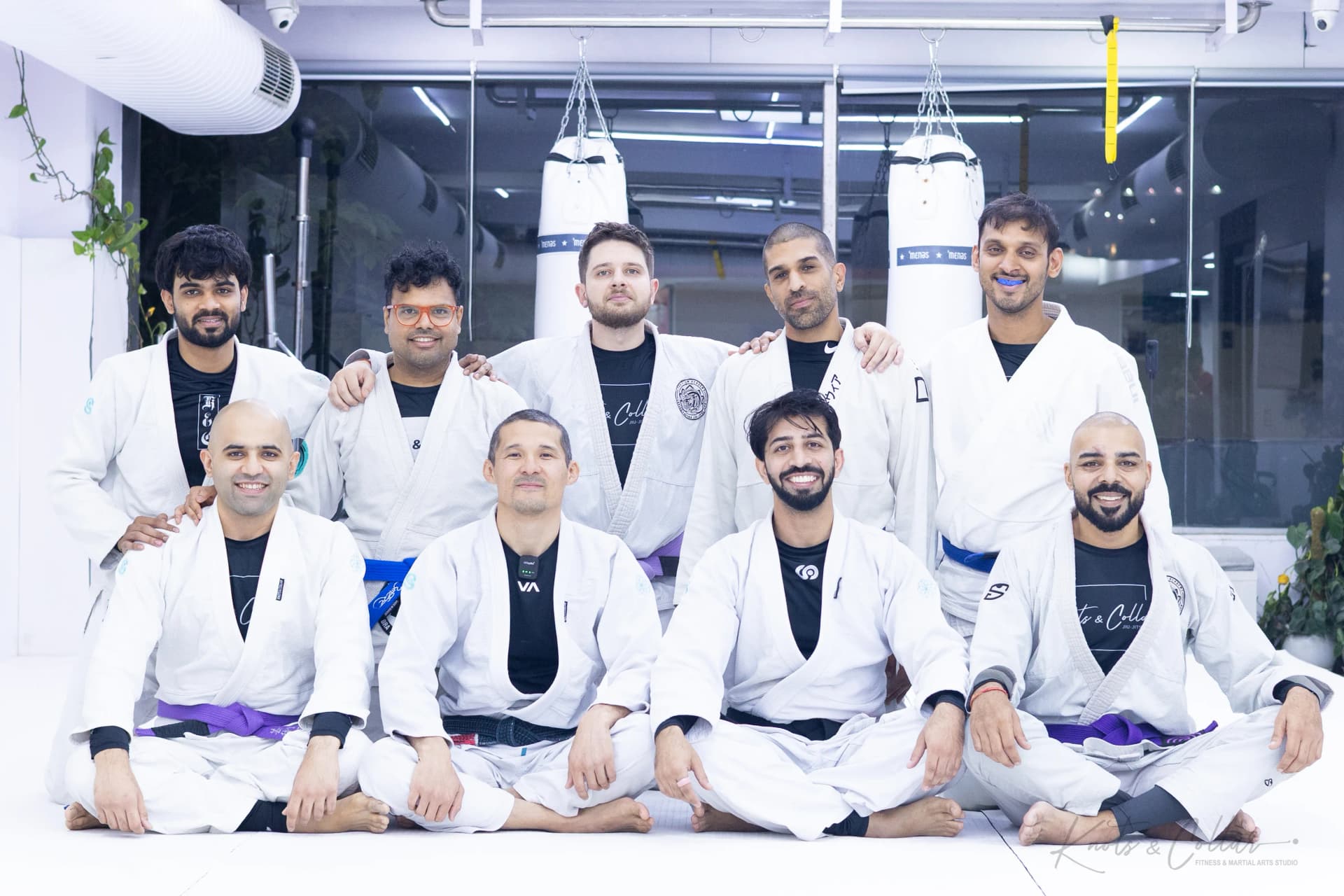 A black belt and a brown belt instructor applauding students during a seminar at Knots & Collar, New Delhi