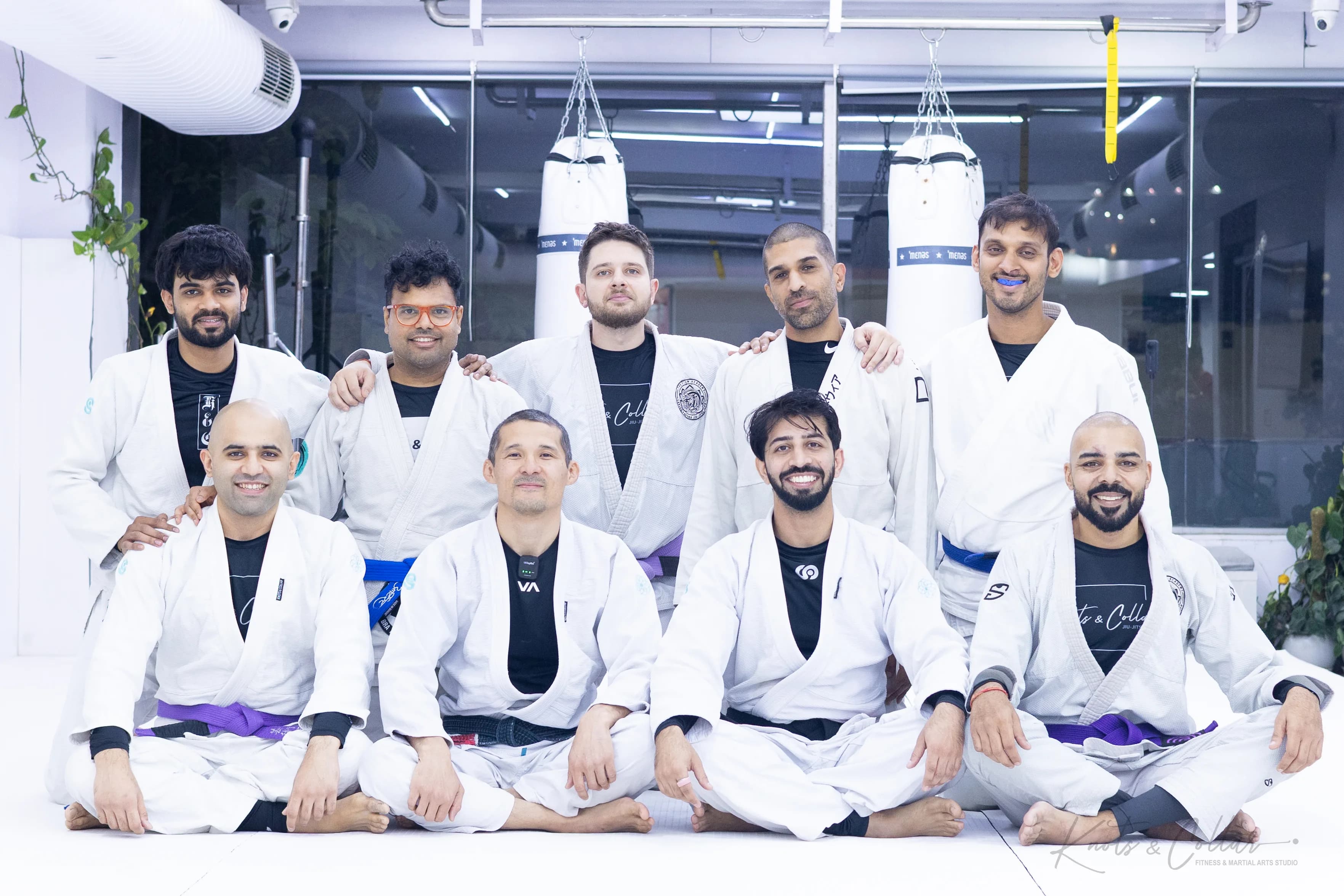 A black belt and a brown belt instructor applauding students during a seminar at Knots & Collar, New Delhi