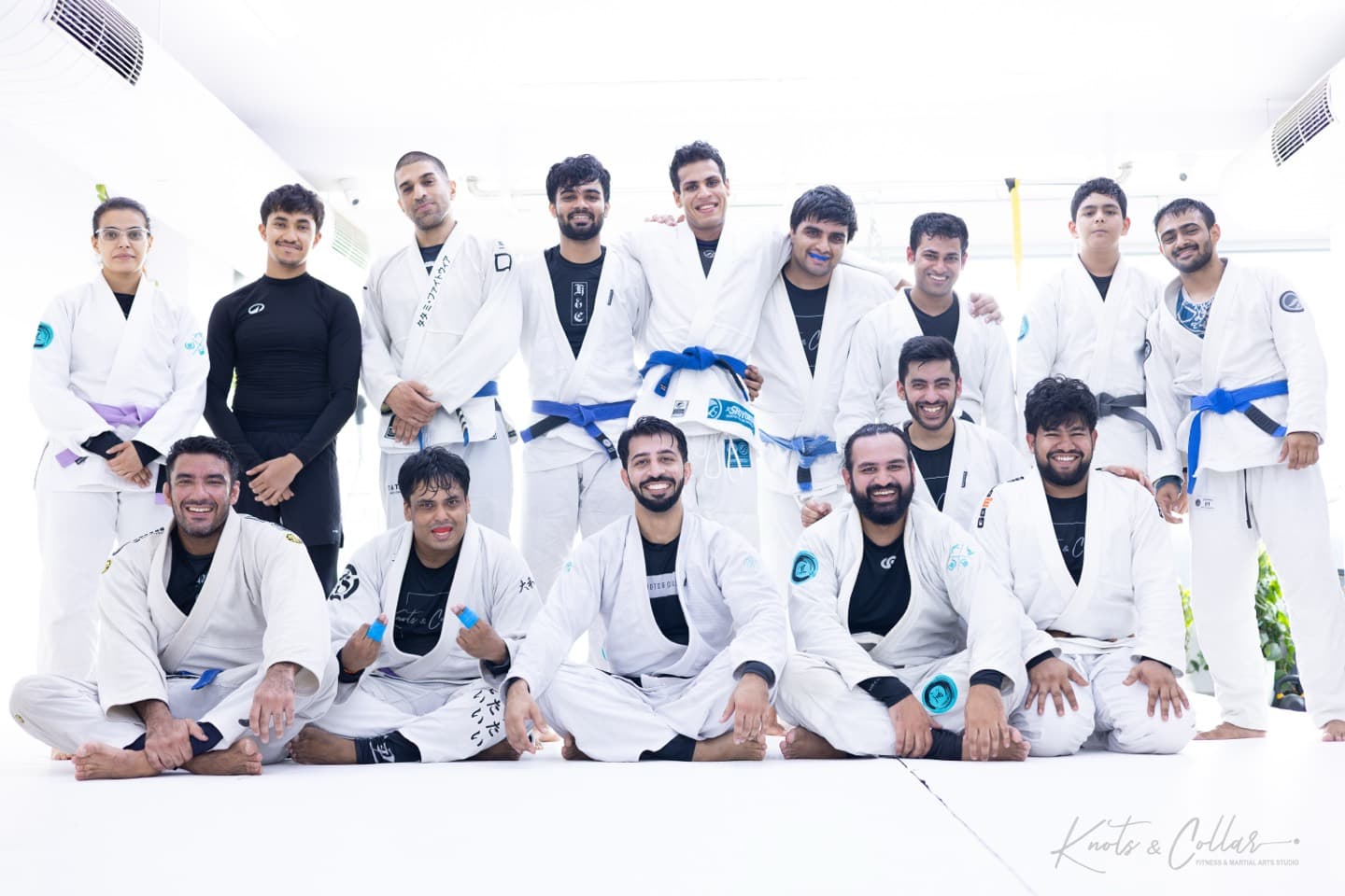 A jiu-jitsu class group in the gi, from white to blue belts, at Knots & Collar in New Delhi
