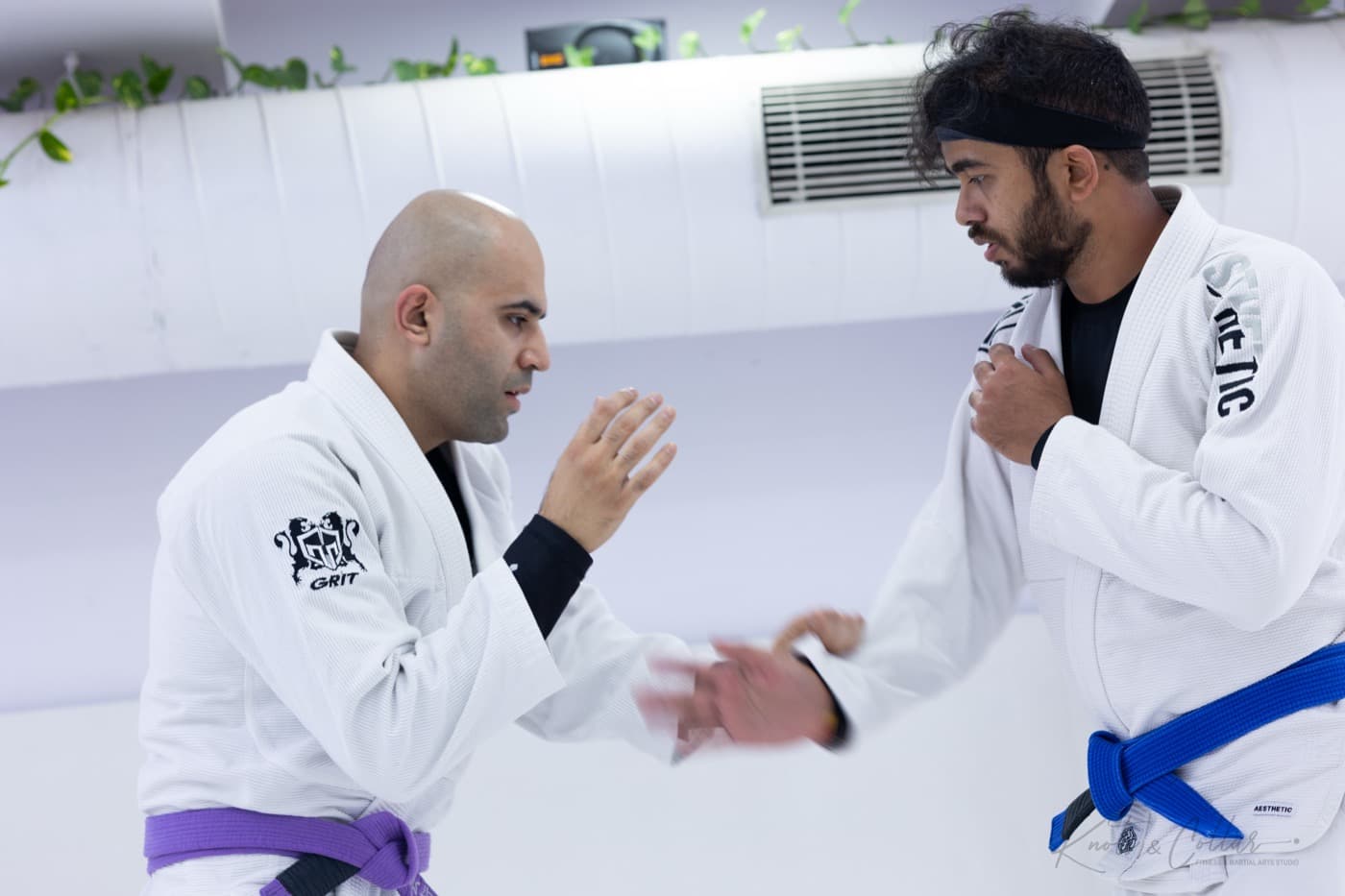 A coach and student hand-fighting in gi jiu-jitsu at Knots & Collar, Defence Colony, New Delhi