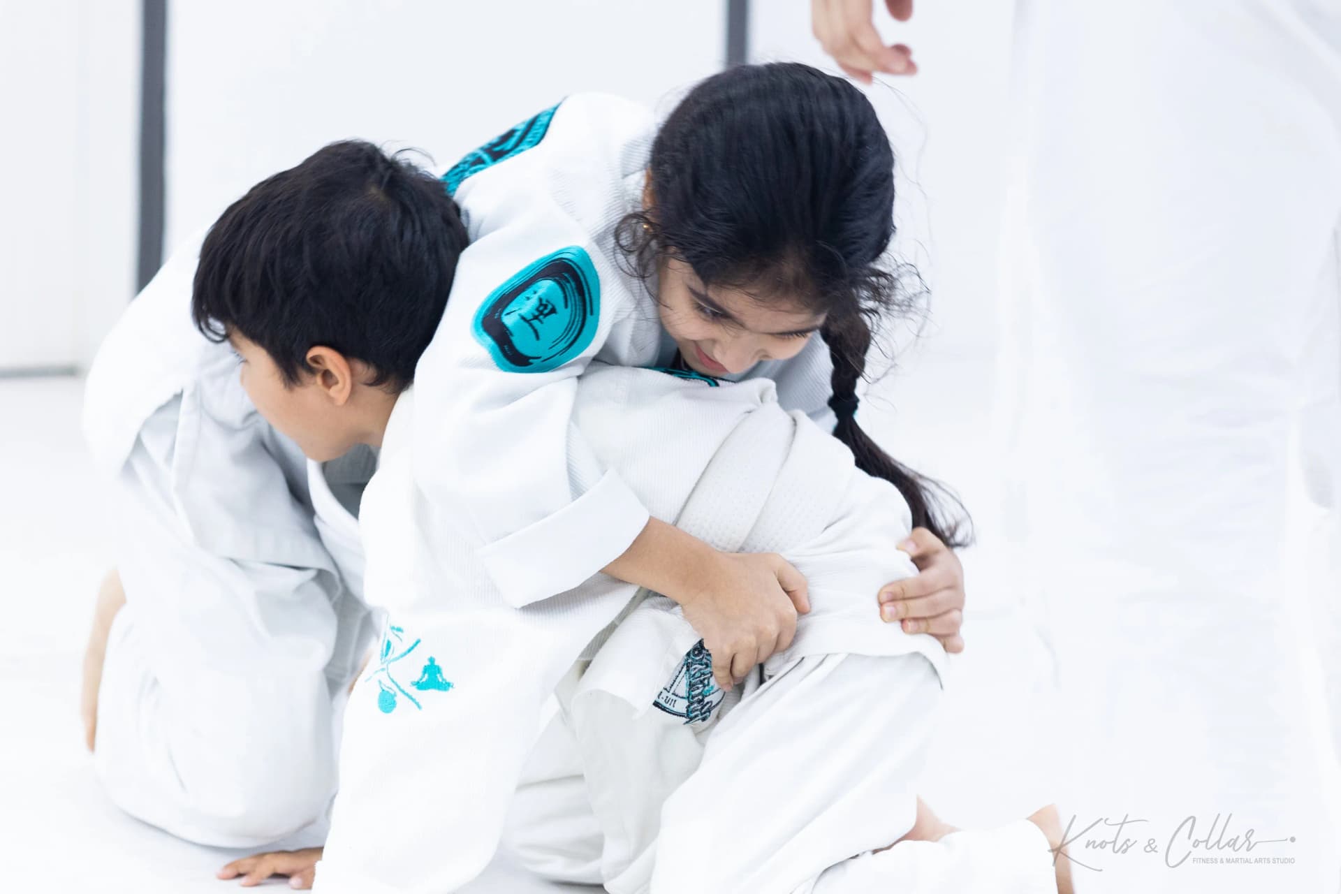 A young student learning a jiu-jitsu position at Knots & Collar, New Delhi