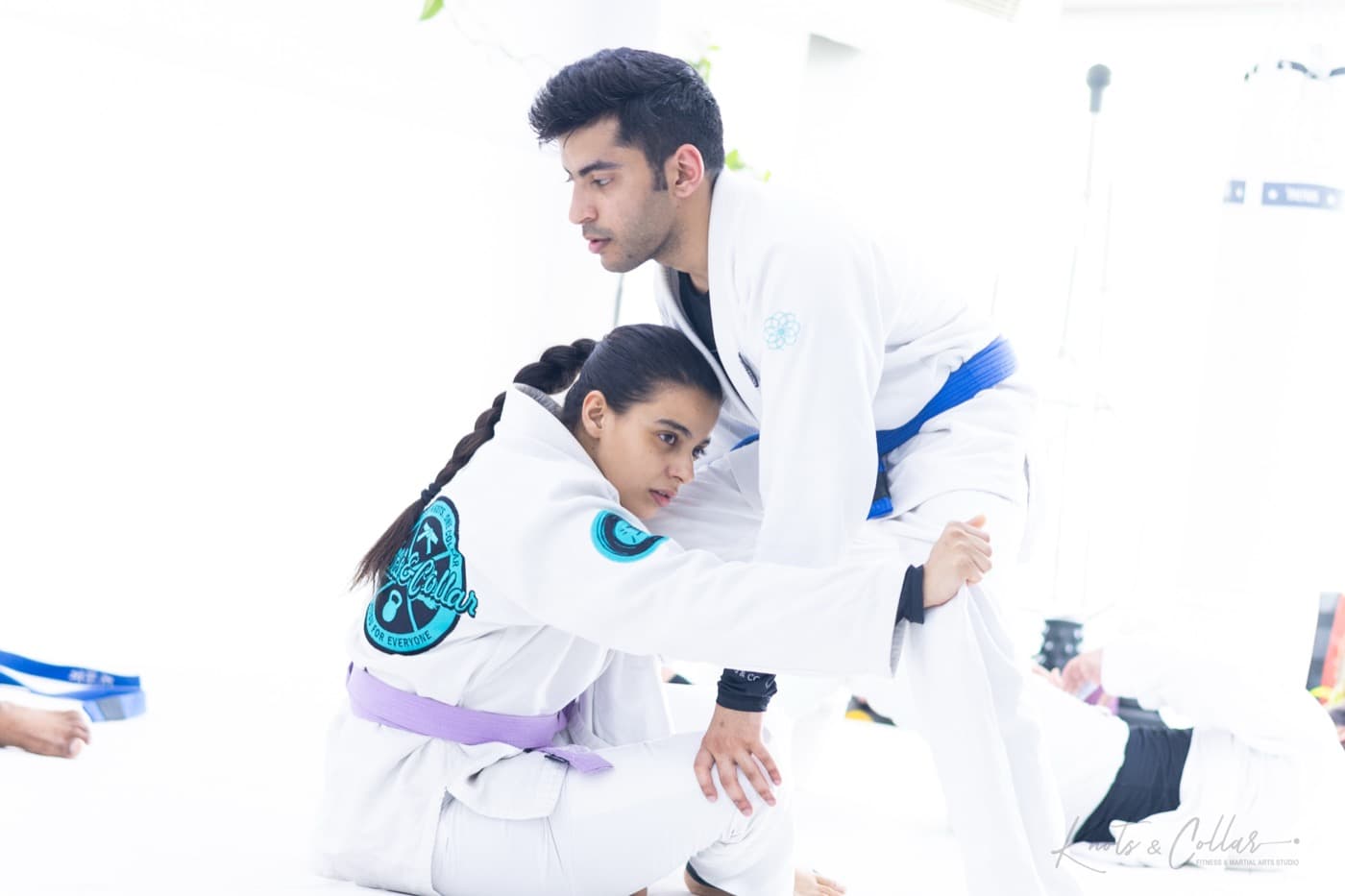 A woman drilling grips in gi jiu-jitsu at Knots & Collar, New Delhi