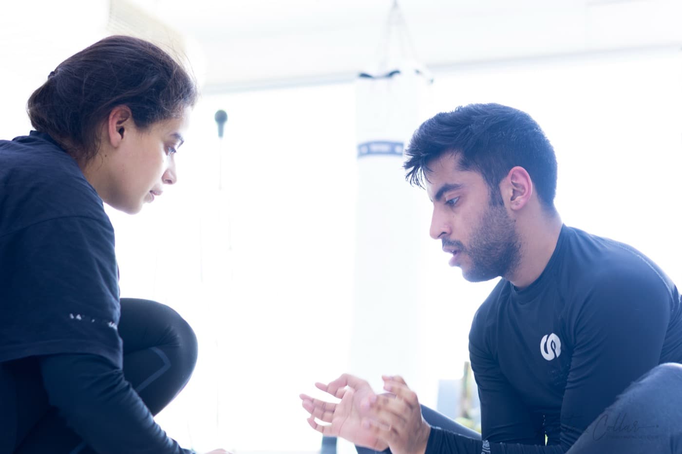 A student and coach talking through a technique at Knots & Collar women's class, New Delhi